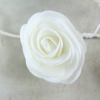 A White Foam Rose As Part Of The Garland