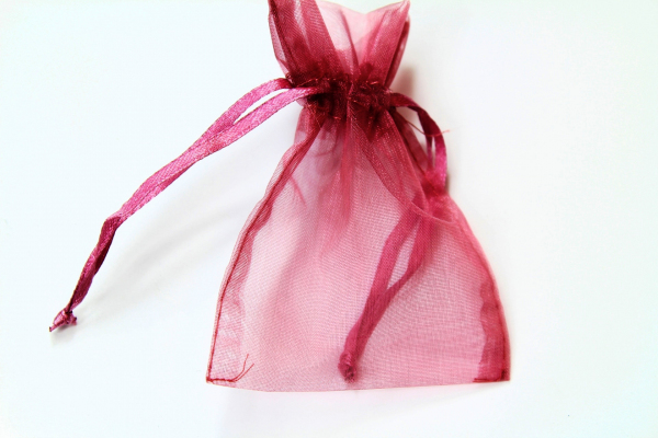 Our dusty Pink Organza bag with matching tie ribbons.